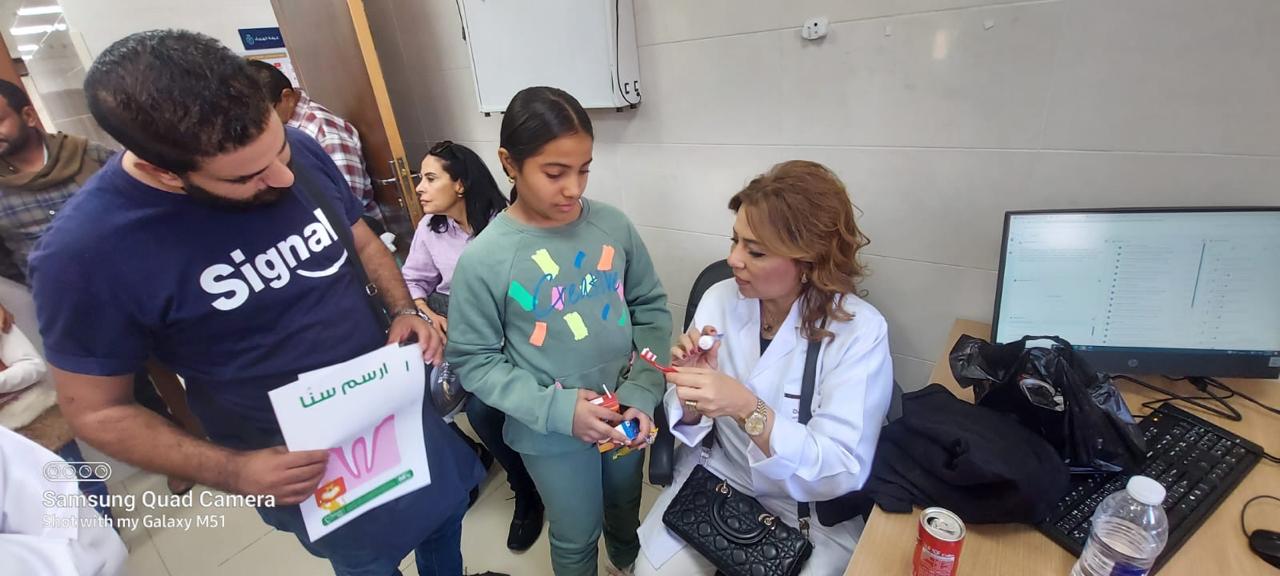 Dentist demonstrating oral hygiene to a student